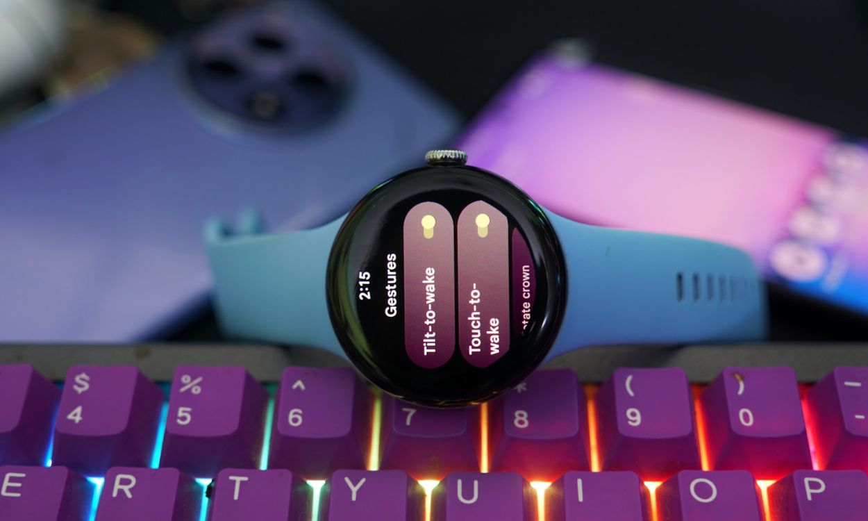 A Google Pixel Watch 2 placed on its side on top of a keyboard