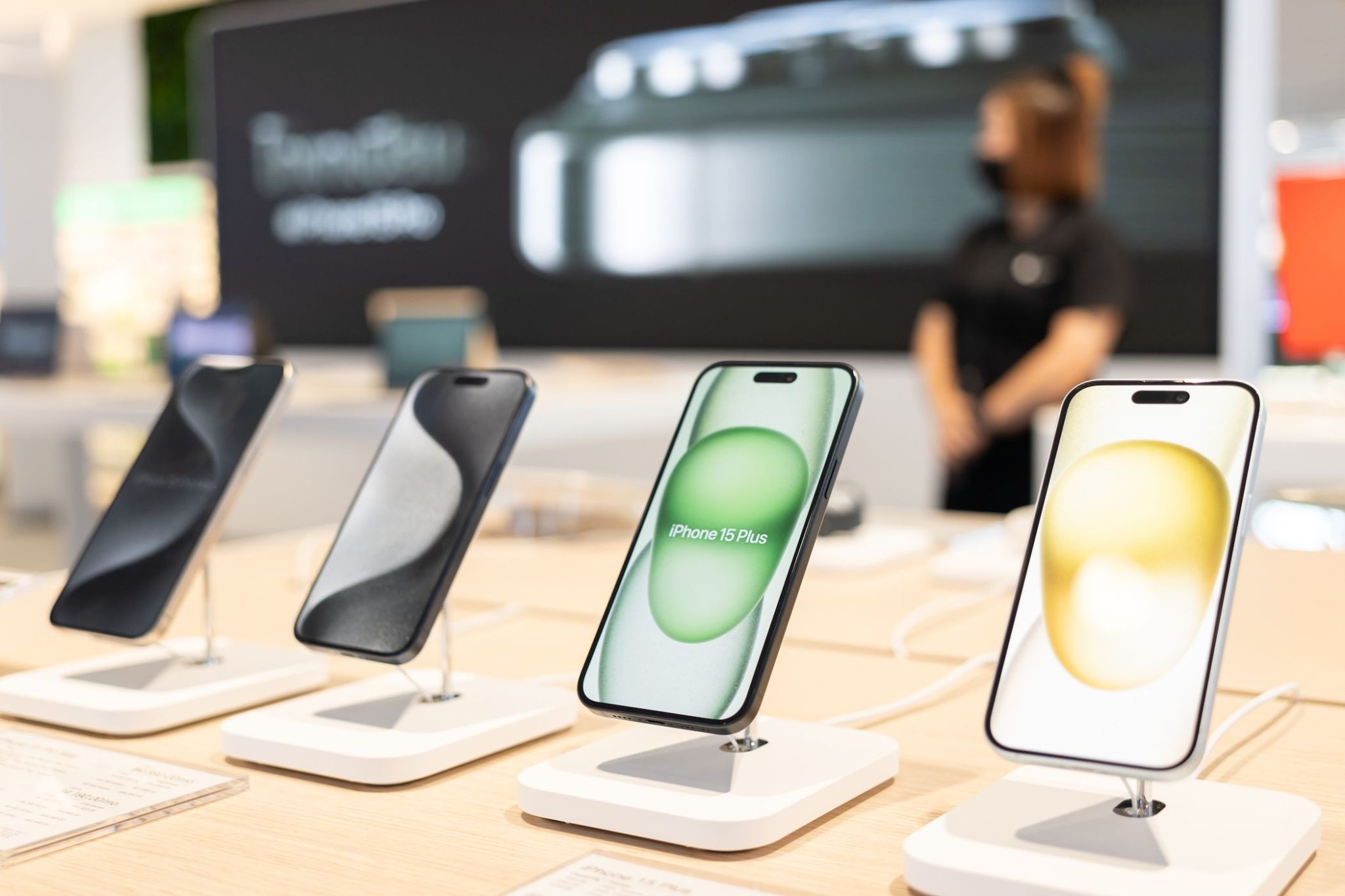 iPhone 15 models on display at an Apple Store